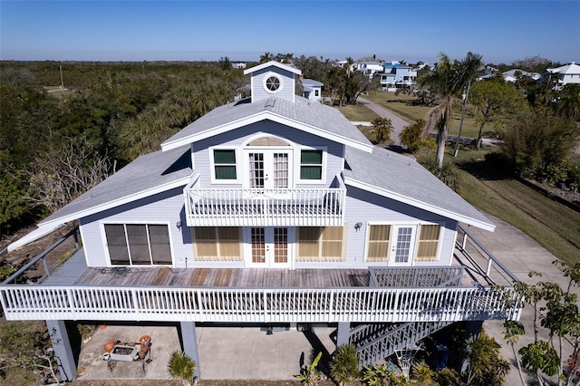 back of house with a wooden deck and french doors