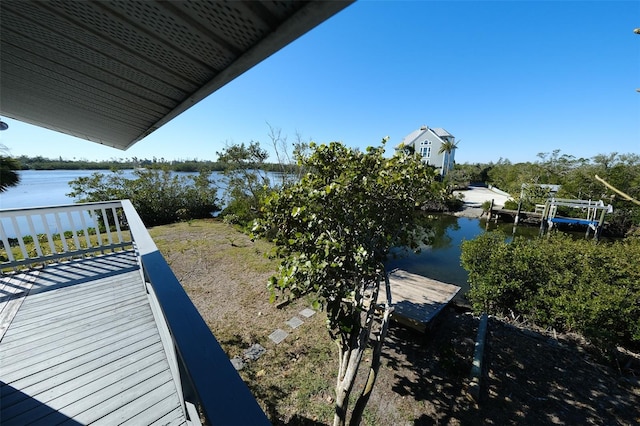 exterior space with a water view and a boat dock