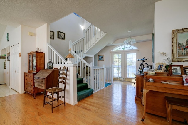 interior space featuring french doors, wood-type flooring, and a textured ceiling