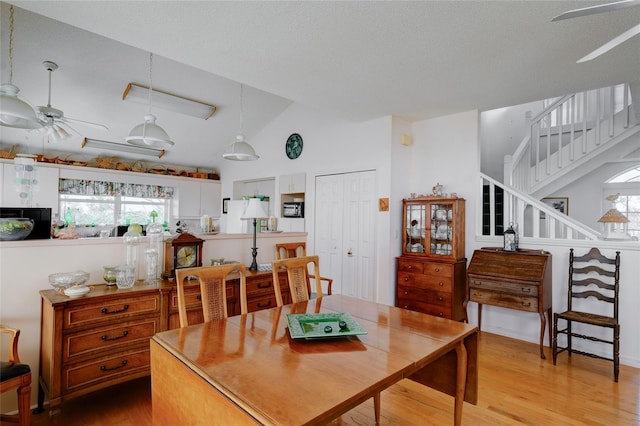 dining space featuring lofted ceiling, a wealth of natural light, and light hardwood / wood-style floors