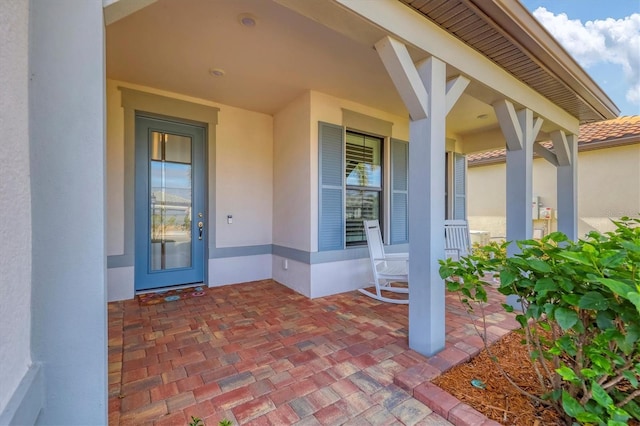 property entrance featuring covered porch