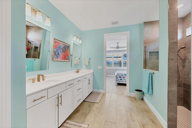 bathroom with vanity and a tile shower