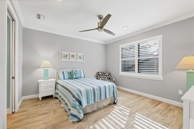 bedroom featuring hardwood / wood-style flooring, ornamental molding, and ceiling fan