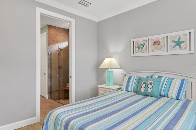 bedroom featuring crown molding, ensuite bath, and light hardwood / wood-style flooring