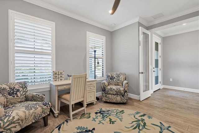 office area with ornamental molding and light hardwood / wood-style floors