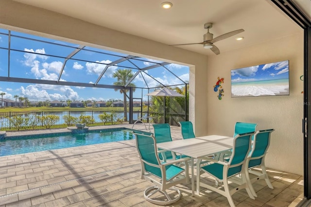 view of pool with a water view, ceiling fan, a lanai, and a patio