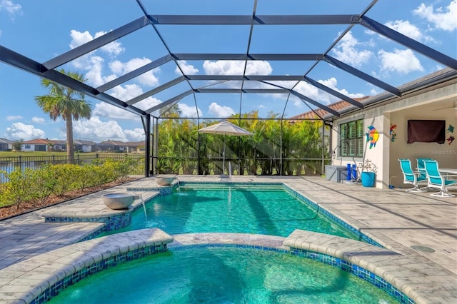 view of swimming pool featuring a lanai and a patio area