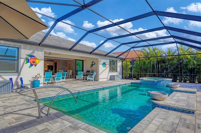 view of swimming pool with pool water feature, glass enclosure, an in ground hot tub, ceiling fan, and a patio