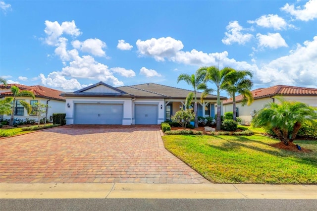 view of front of house with a garage and a front lawn