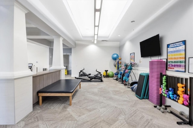 exercise room with a raised ceiling