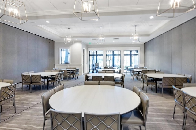 dining area featuring ornamental molding and a raised ceiling