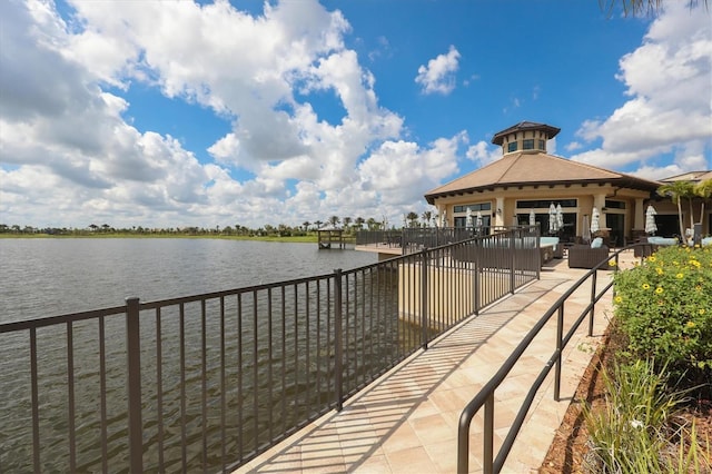 surrounding community featuring an outdoor living space and a water view