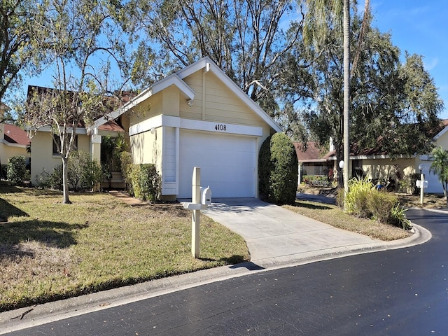 view of front of property with a garage and a front lawn