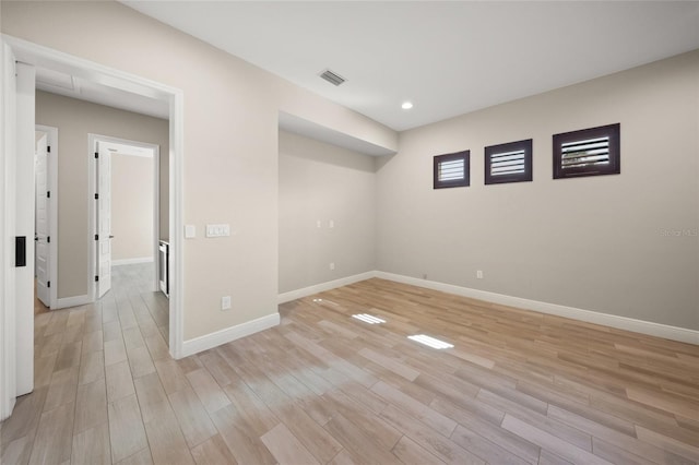 unfurnished room with light hardwood / wood-style floors