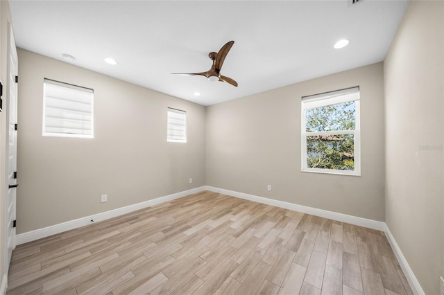 empty room featuring ceiling fan and light hardwood / wood-style floors