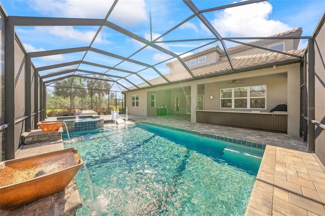 view of swimming pool featuring an in ground hot tub, a lanai, pool water feature, and a patio