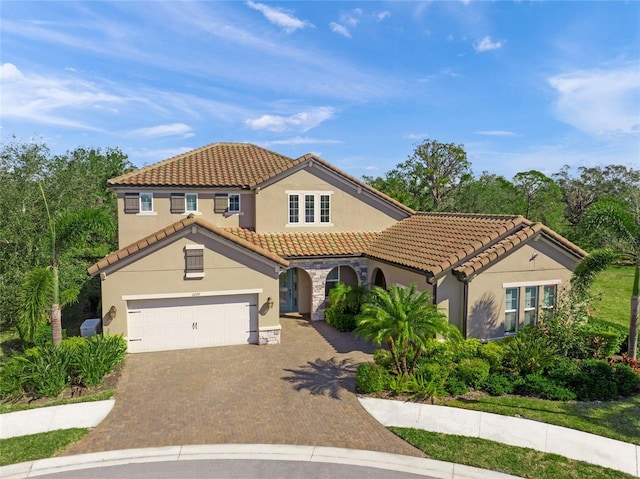 mediterranean / spanish home featuring a garage