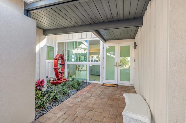 view of exterior entry with french doors and a patio