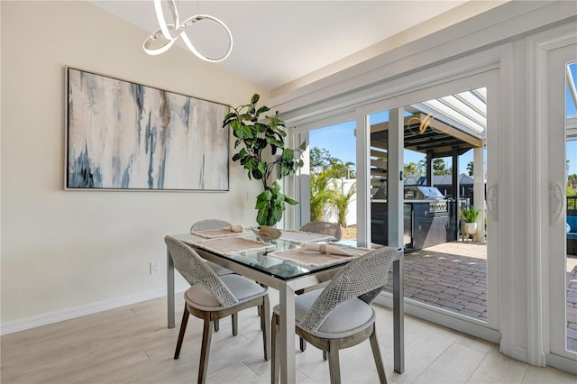 dining area with a notable chandelier and light wood-type flooring