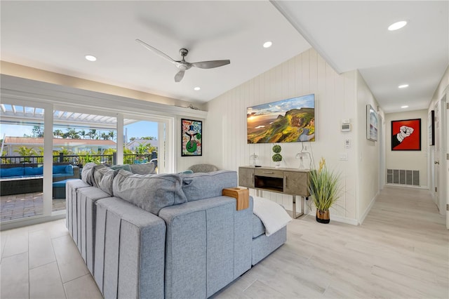 living room with light hardwood / wood-style floors and ceiling fan