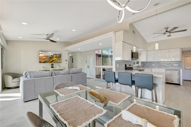 dining room with sink, ceiling fan, and light wood-type flooring