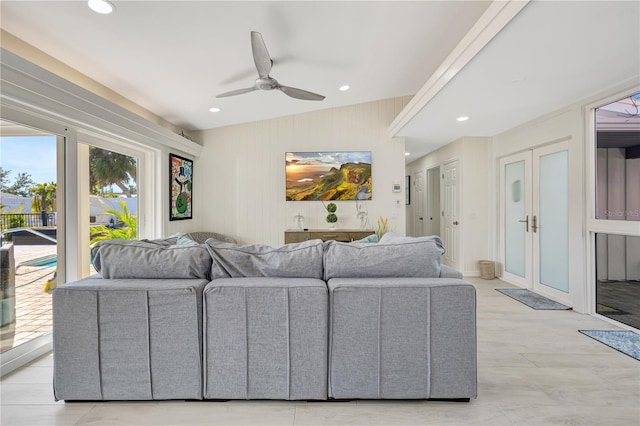 living room featuring vaulted ceiling, french doors, and ceiling fan