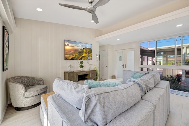 living room with ceiling fan, a fireplace, and light hardwood / wood-style floors