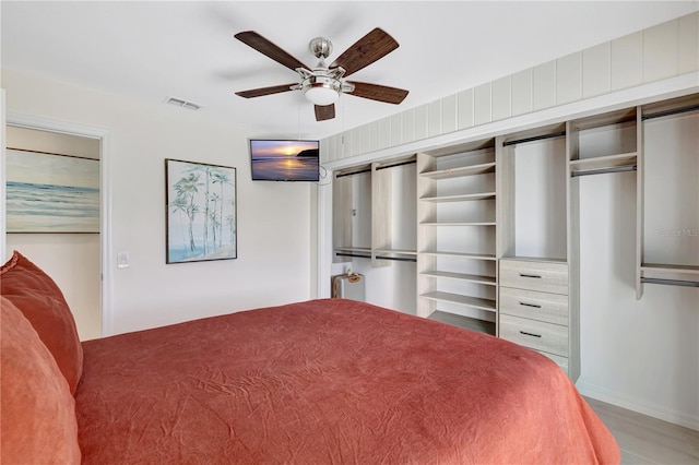 bedroom featuring hardwood / wood-style flooring, a closet, and ceiling fan