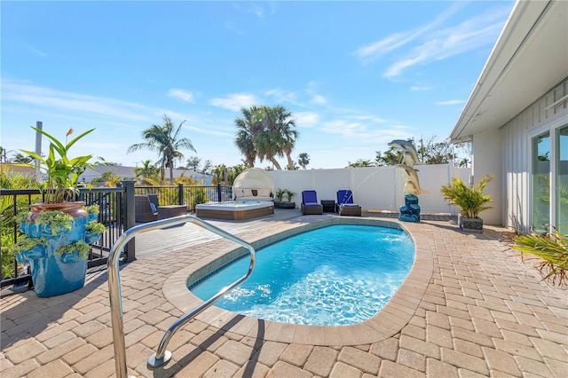 view of pool featuring pool water feature, an outdoor hot tub, and a patio area