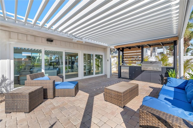 view of patio / terrace featuring an outdoor living space, an outdoor kitchen, and a grill