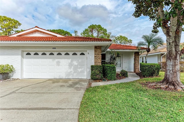 view of front of home featuring a garage and a front lawn