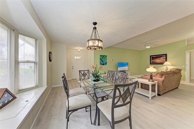 dining room with a chandelier and light hardwood / wood-style flooring