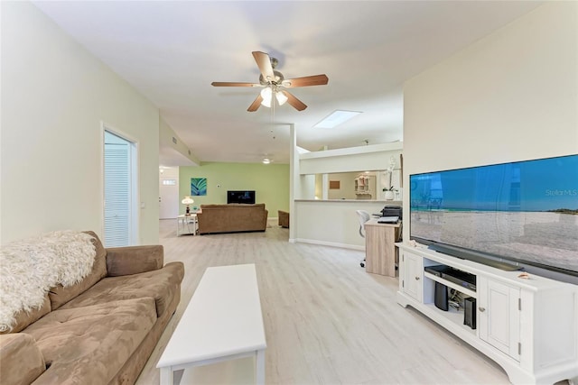 living room featuring ceiling fan and light wood-type flooring