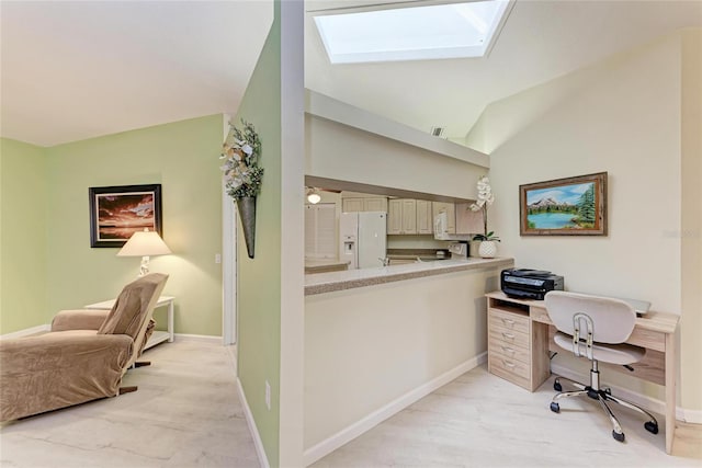 office with lofted ceiling with skylight