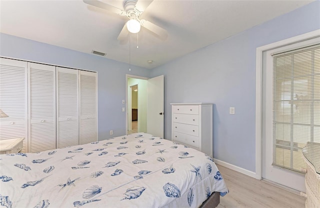 bedroom with light hardwood / wood-style flooring, a closet, and ceiling fan