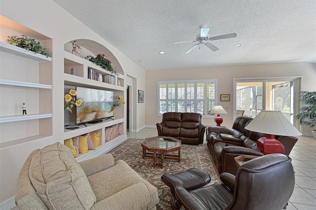 living room featuring tile patterned floors, built in features, a textured ceiling, baseboards, and ceiling fan