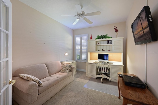 office space featuring a ceiling fan and carpet