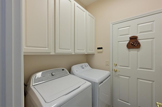 laundry room featuring cabinet space and washer and clothes dryer