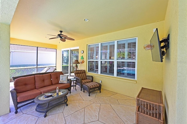 sunroom / solarium featuring a wealth of natural light and ceiling fan