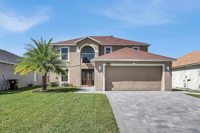 view of front of home with a garage and a front yard