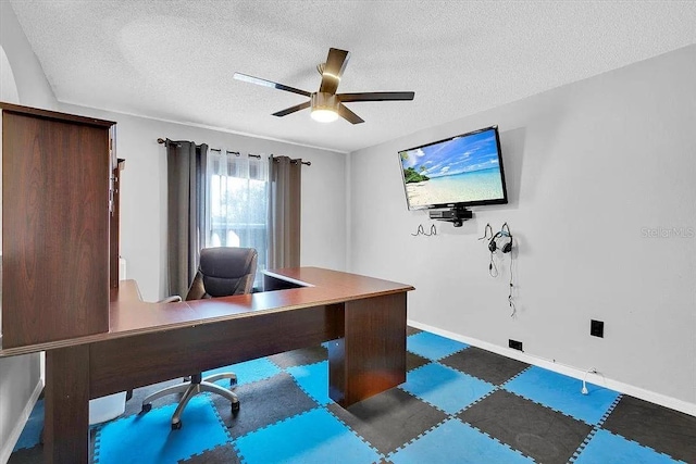 office with ceiling fan and a textured ceiling