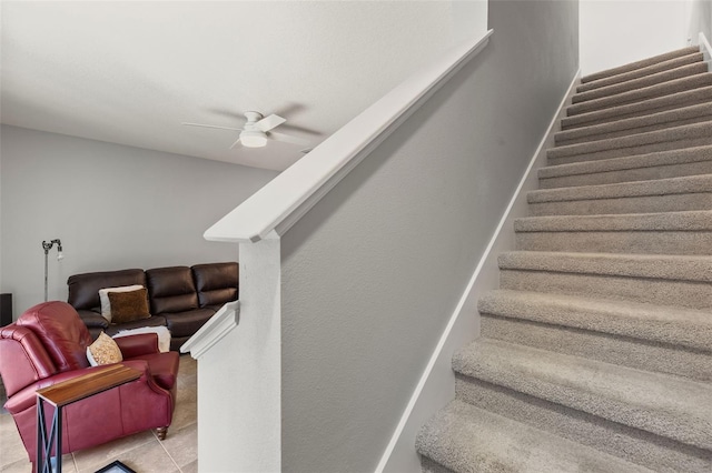 staircase featuring tile patterned flooring and ceiling fan