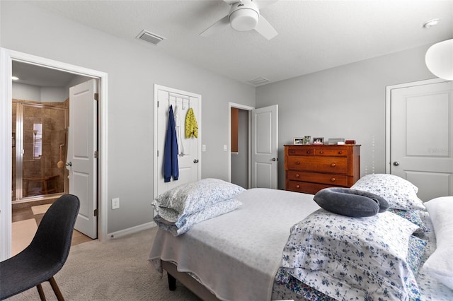 bedroom with ceiling fan, light colored carpet, and connected bathroom