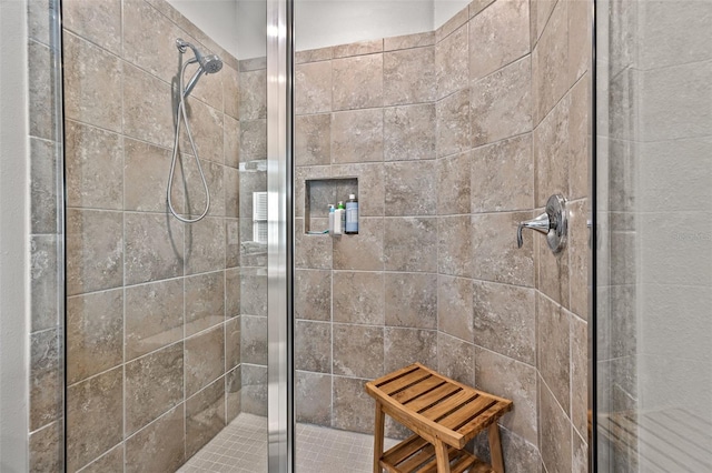 bathroom with a shower with door