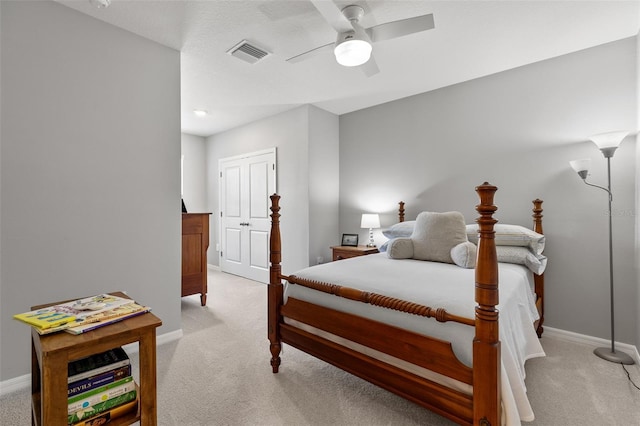 bedroom with light carpet and ceiling fan