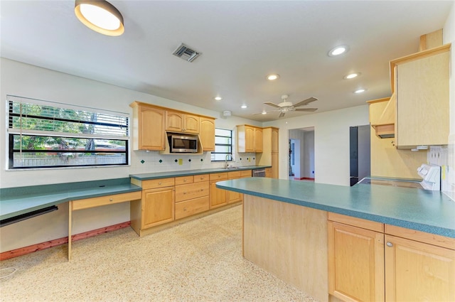 kitchen with light brown cabinetry, sink, backsplash, ceiling fan, and stainless steel appliances