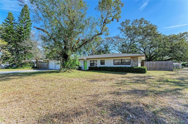 ranch-style home with a garage and a front yard