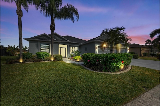 ranch-style home with a yard