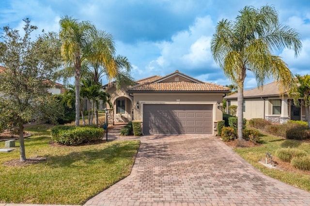 mediterranean / spanish-style house with a garage and a front lawn