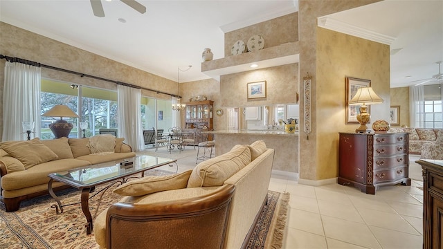 living room with crown molding, ceiling fan, and light tile patterned floors